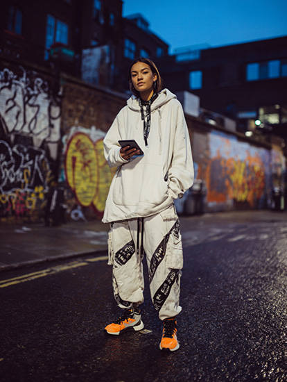 A teenage girl in a London street with an Apple iPad mini 4