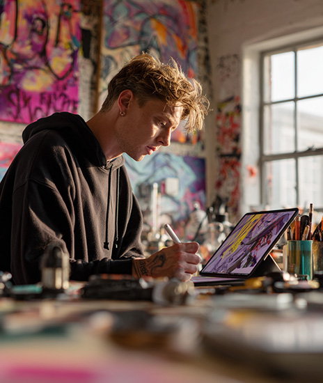 A professional graphic designer using their iPad Pro 12.9 for graphic art