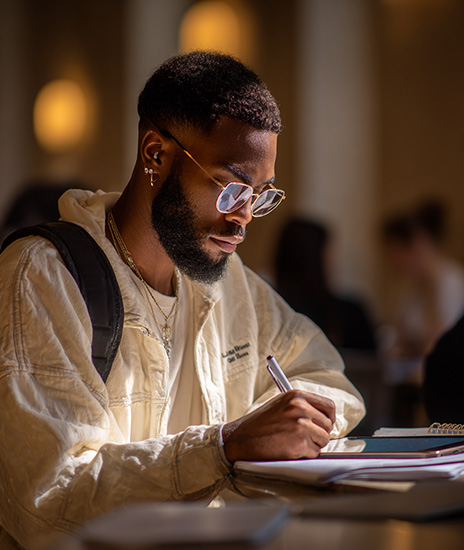 A university student using an iPad Pro 9.7 to help their studies