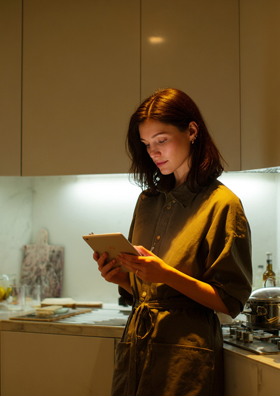 A young professional at home using an iPad to look up recipes